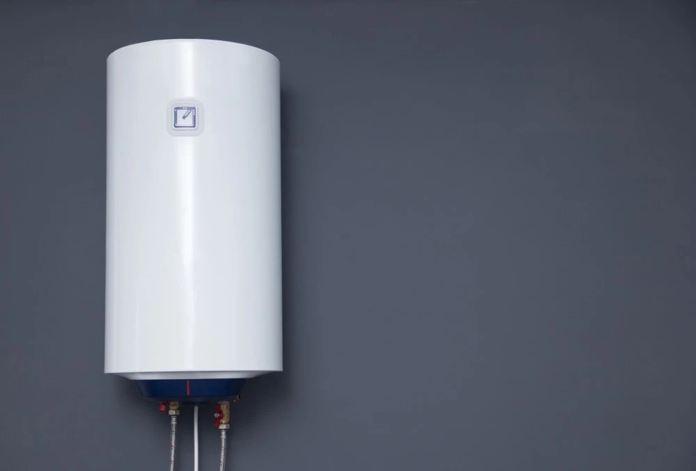 Technician installing a large-capacity commercial water heater in a Dubai facility
