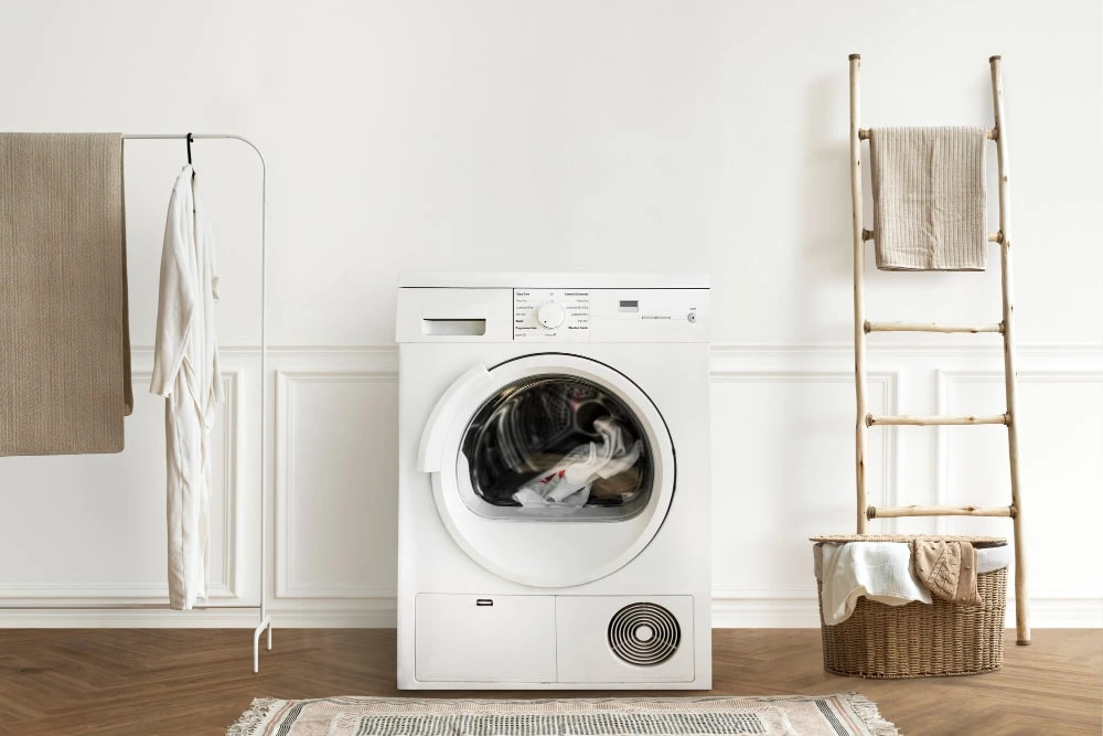 Technician installing a semi-automatic washing machine in a Dubai residential utility area