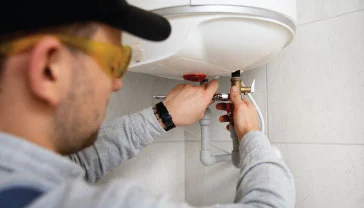 Certified technician performing water heater installation in a Dubai